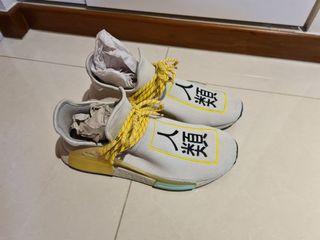 On feet: #adidas x Pharrell Williams NMD Human Race Blk. In hand