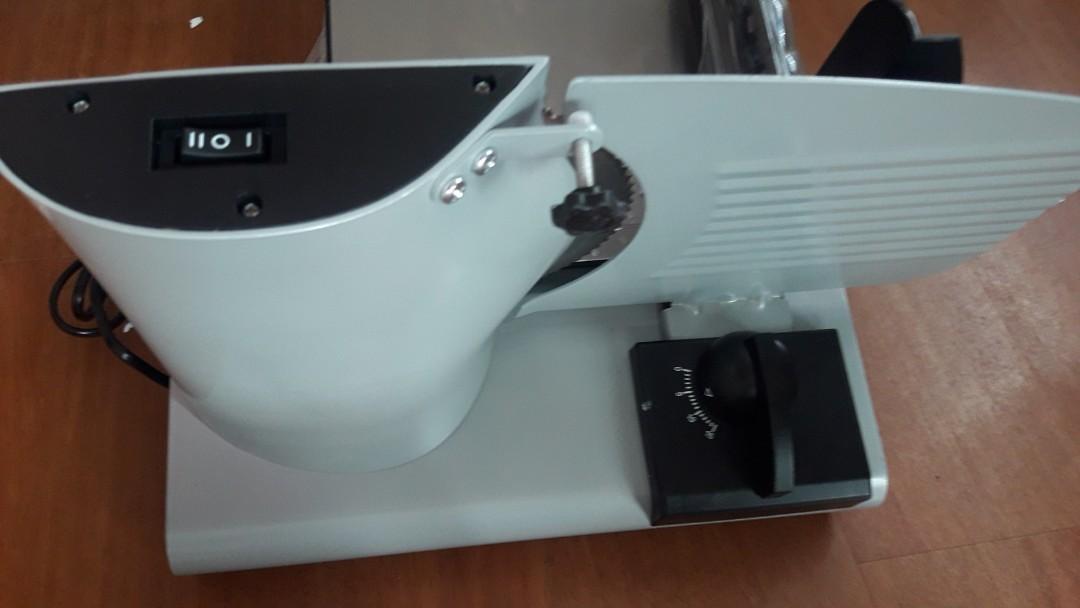 Food and meat Slicer (Category: Knives & Chopping Boards) located in Manila. Submitted by PickClickShip (Listing ID 1076455355, Image 3). Description: Food and meat Slicer A slicer for your meat and other food in your kitchen. Simple to use and operate. - 200W - Diameter of blade: 190mm - stainless steel blade - adjustable thickness - dishwasher safe - removable carriage and food holder - can easily clean the blade and the slicer - 2 lever speed 