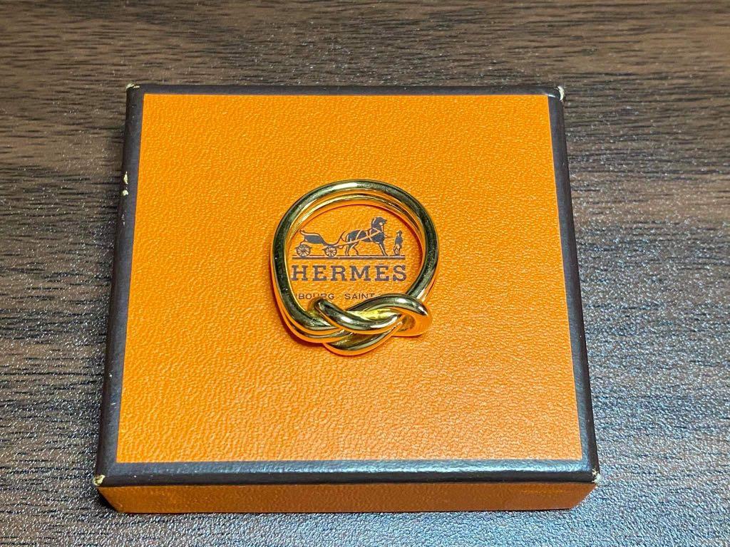 Preloved Authentic Vintage Hermès Knot Scarf Ring (Category: Luxury Accessories) located in Makati City. Submitted by golden_gate_bridge (Listing ID 1073566270, Image 2). Description: Preloved Authentic Vintage Hermès Knot Scarf Ring Crafted in permabrass, this gold toned ring will do wonders accenting your favorite scarf Hardly used. Authentic Hermes box included Guaranteed authentic. .