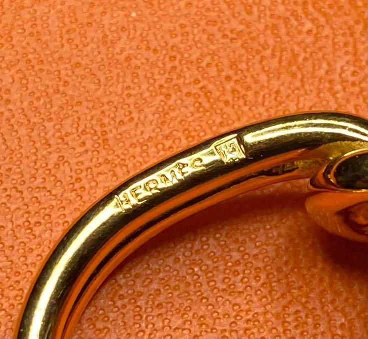 Preloved Authentic Vintage Hermès Knot Scarf Ring (Category: Luxury Accessories) located in Makati City. Submitted by golden_gate_bridge (Listing ID 1073566270, Image 3). Description: Preloved Authentic Vintage Hermès Knot Scarf Ring Crafted in permabrass, this gold toned ring will do wonders accenting your favorite scarf Hardly used. Authentic Hermes box included Guaranteed authentic. .
