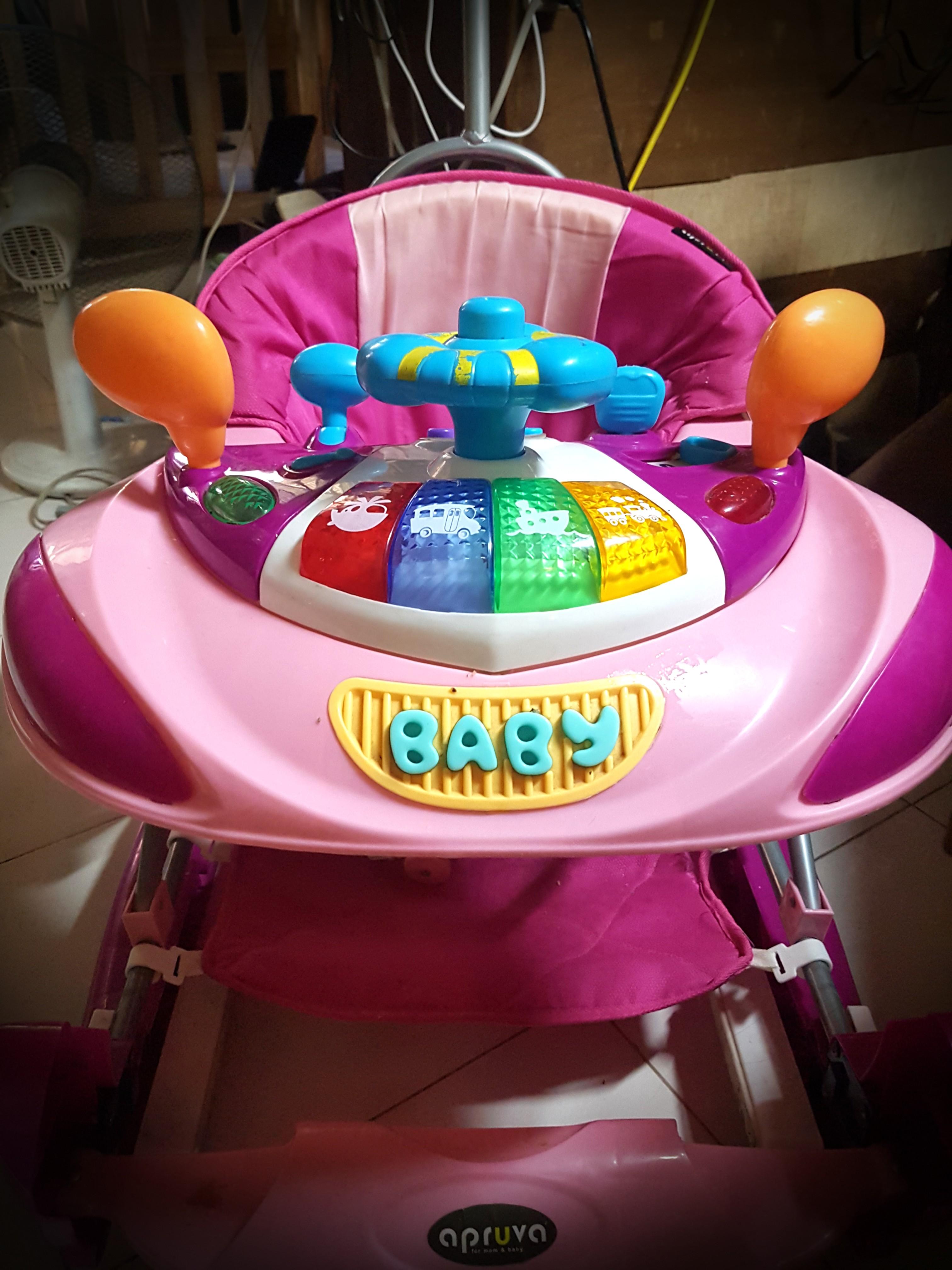 Apruva 3 in 1 Walker (Category: Infant Playtime) located in Caloocan City. Submitted by _nayeonyny (Listing ID 1084712572, Image 1). Description: Apruva WG-50R 2 in 1 Convertible Pink Walker for Baby with Rocker used by my niece Mall Price: 3499 php 3 in 1 - walker, eating chair with music, rocker. flaws: please check 2nd image tas yung paint sa wheel nagffade na. with box.