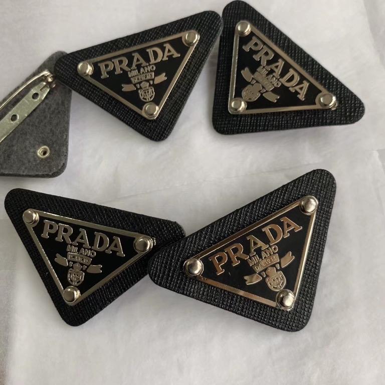 Prada Brooch (Preorder) (Category: Luxury Accessories) located in Malabon City. Submitted by designerarchives.ph (Listing ID 1080360965, Image 1). Description: Colors: Black, White Add 200 if you want with box 50% Downpayment required to order Buyer will shoulder the shipping 1-2 weeks ETA Tags: Chanel Brooch.