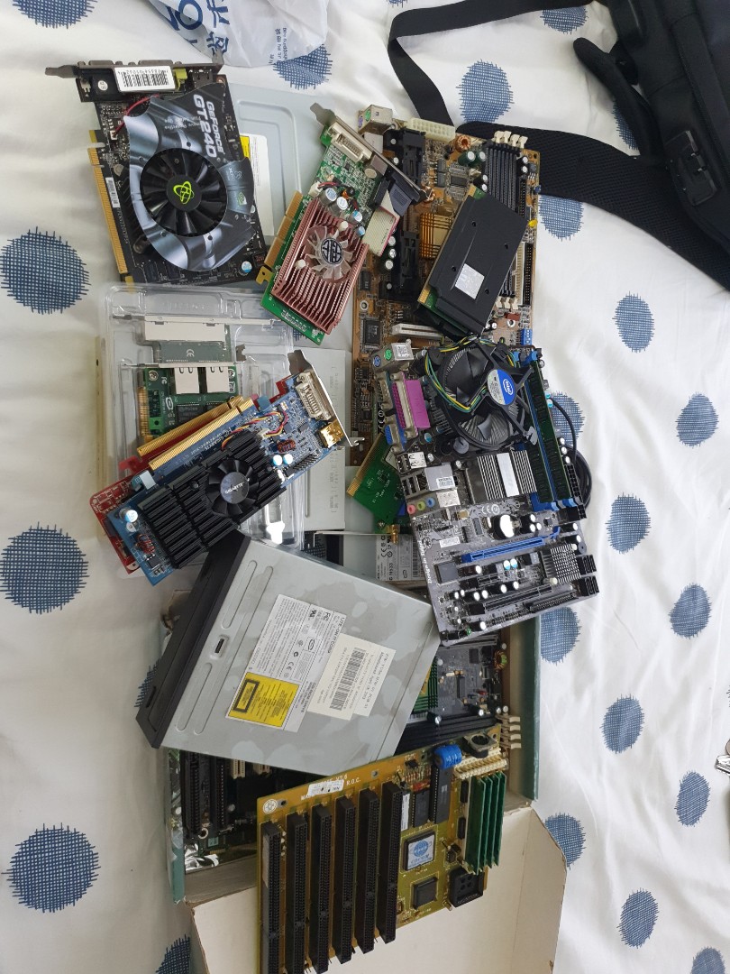 A pile of old Computer parts. GPU cards, network cards, old mobo, etc ...