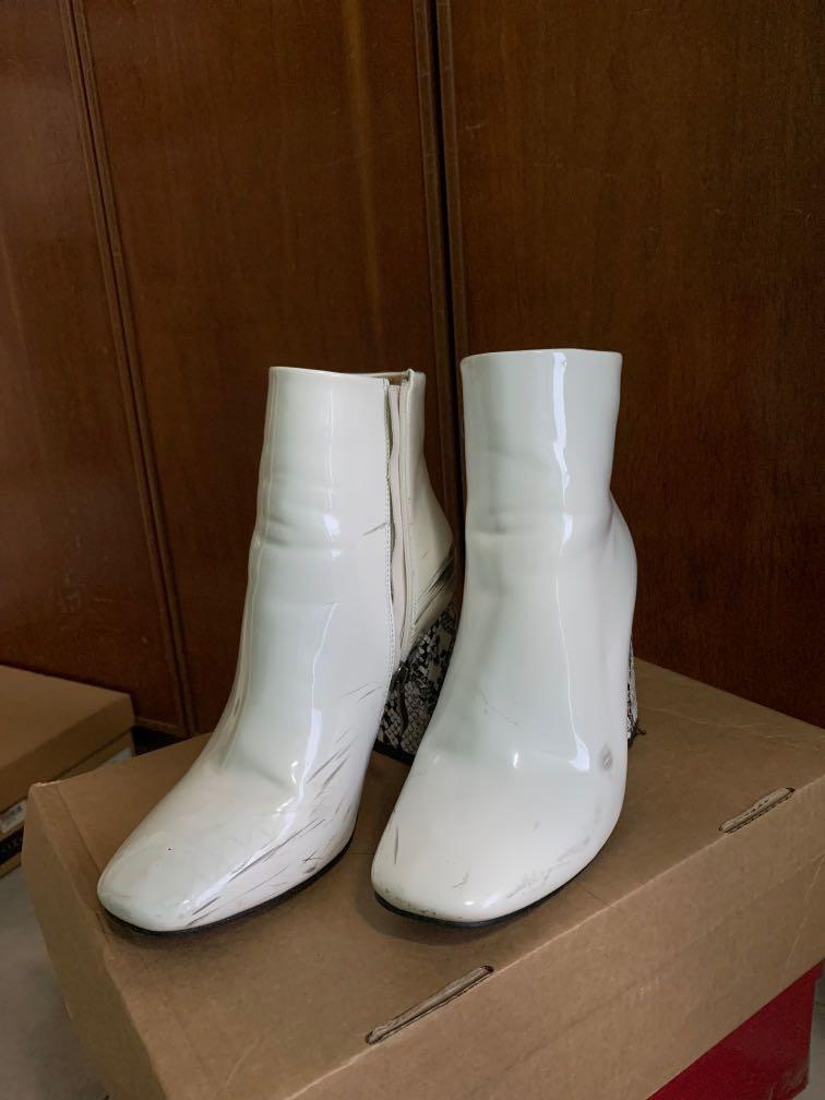 White boots with snakeskin heels