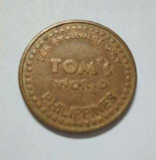 Tom's World Philippines, amusement token (copper type), scarce variety, almost uncirculated condition