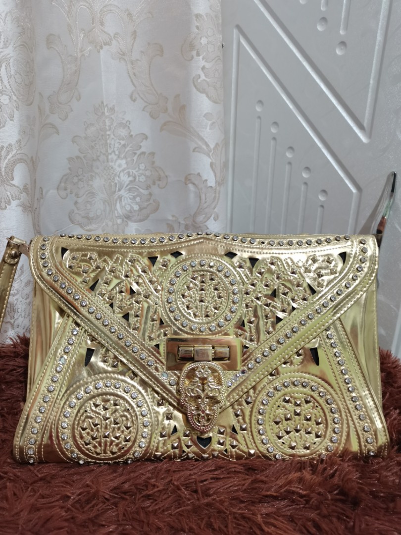 gold studded clutch bag