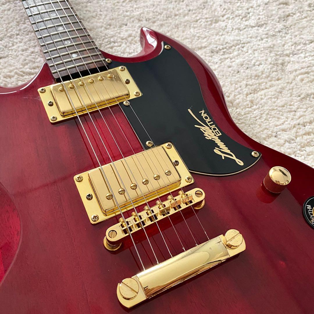 red and gold electric guitar
