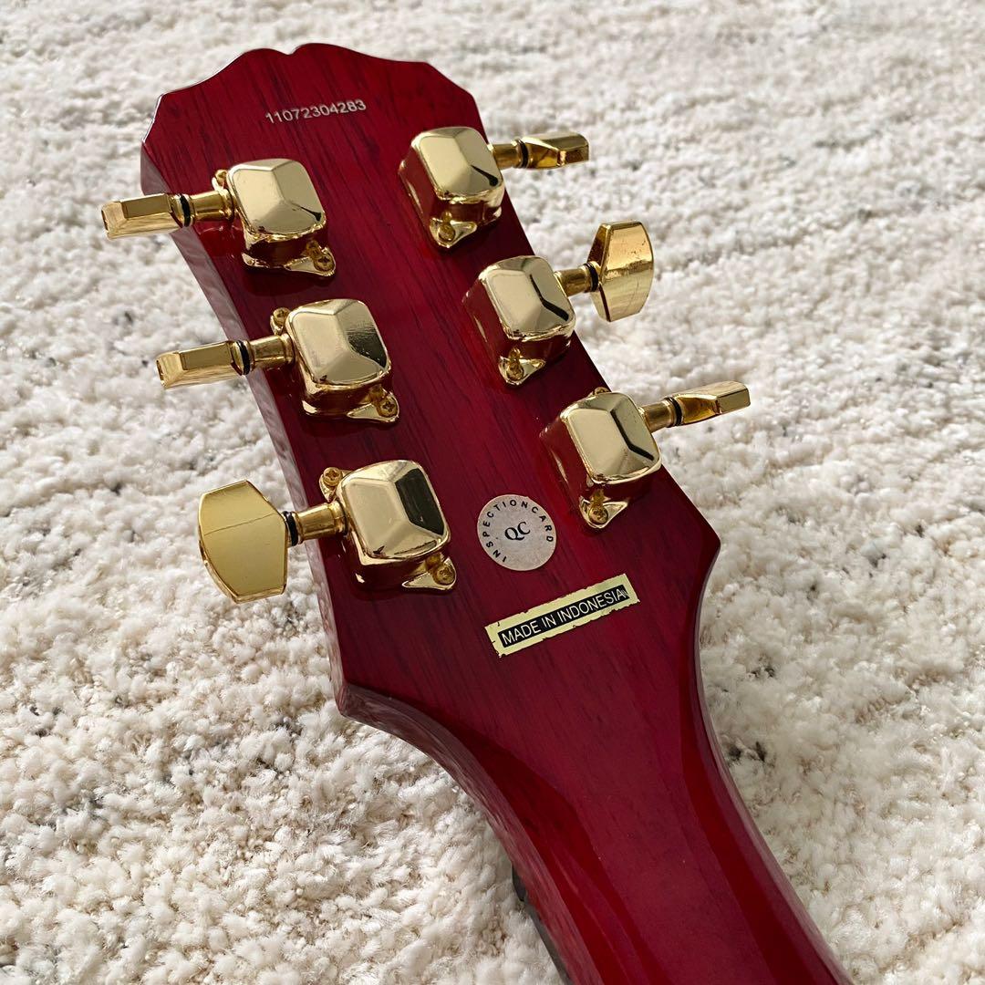 red and gold electric guitar