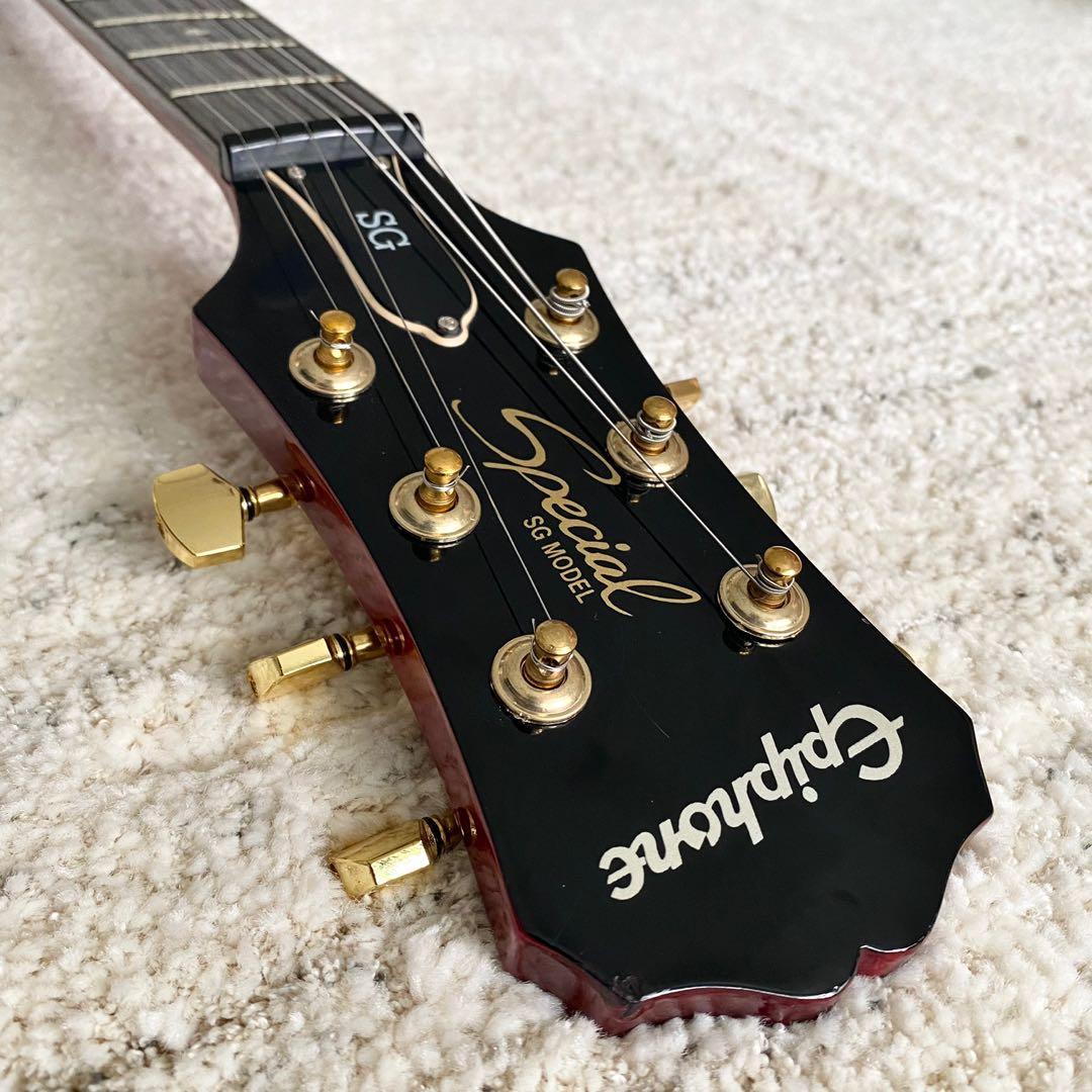 red and gold electric guitar