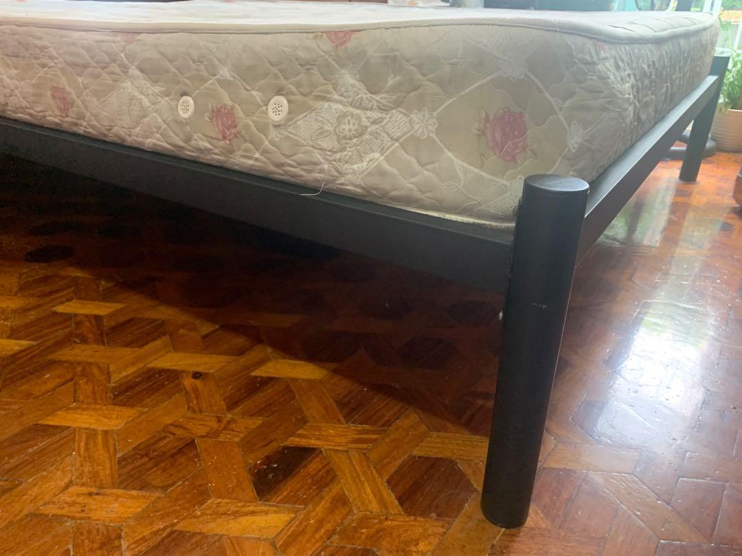 Queen size - Wooden and steel frame bed (Category: Bed Frames & Mattresses) located in Mandaluyong City. Submitted by malola (Listing ID 1088949006, Image 2). Description: Wooden bed with mattress for sale. Good quality. Used for guests in house. Not regularly used. Old with chips on wood looks rustic can be as is or repainted w varnish. Thick Mattress 7 1/2” high, hard good quality good for bad back. .