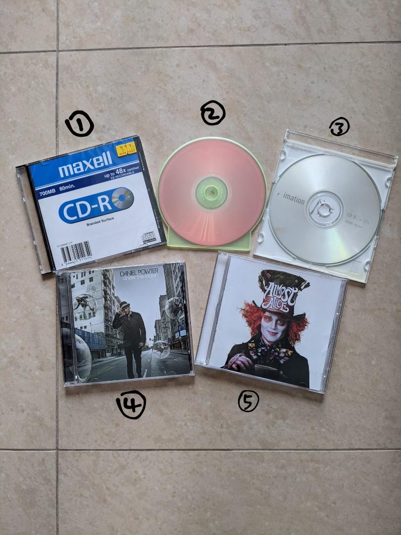 assorted CDs (Category: CDs & DVDs) located in Singapore. Submitted by averysubtleart (Listing ID 1091210123, Image 1). Description: details: #1: CD-R, BNIB #2: i think is CD-R but it has a hot wheels game on it that runs (i checked) 😂 #3: CD-RW, erased so it's a blank copy #4: daniel powter's under the radar (2008) #5: alice in wonderland (2010, dir. tim burton) OST - all CDs are working! - you can turn the blanks into mixtapes, have a hit of n