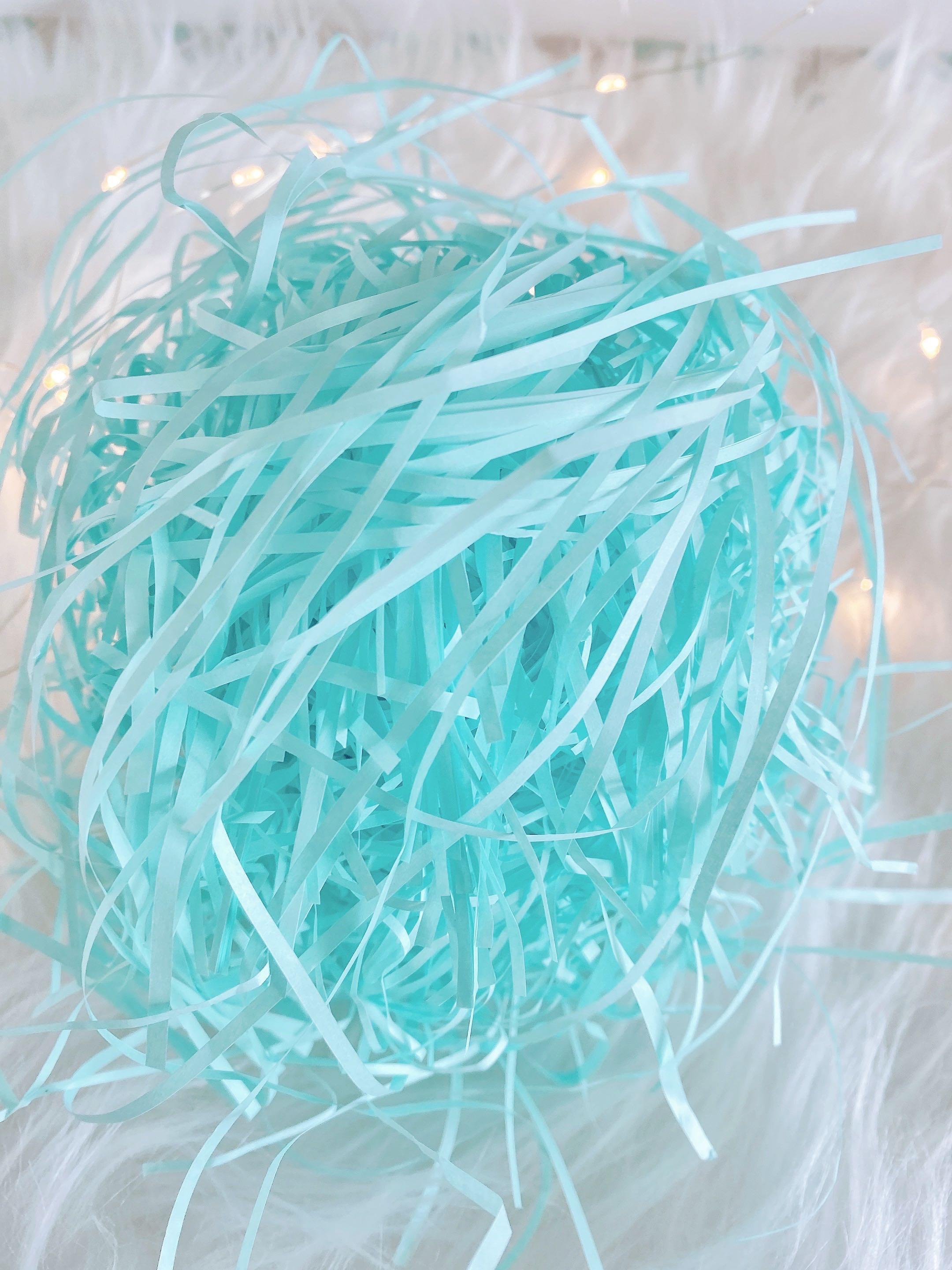 Shredded paper, confetti paper cushioning fill in baby blue for cake