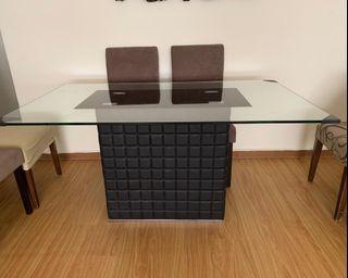 Dining table  with tempered glass top with leather base.