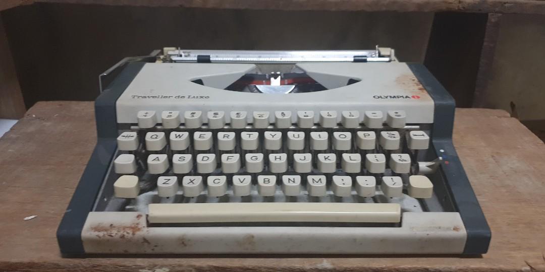 Olympia Traveller Deluxe Typewriter (Category: Office & Business Technology) located in Manila. Submitted by zandre615 (Listing ID 1095276209, Image 1). Description: Olympia traveller deluxe typewriter All keys working With some rust on metal body Plastic cover with crack, check photo Add shipping.