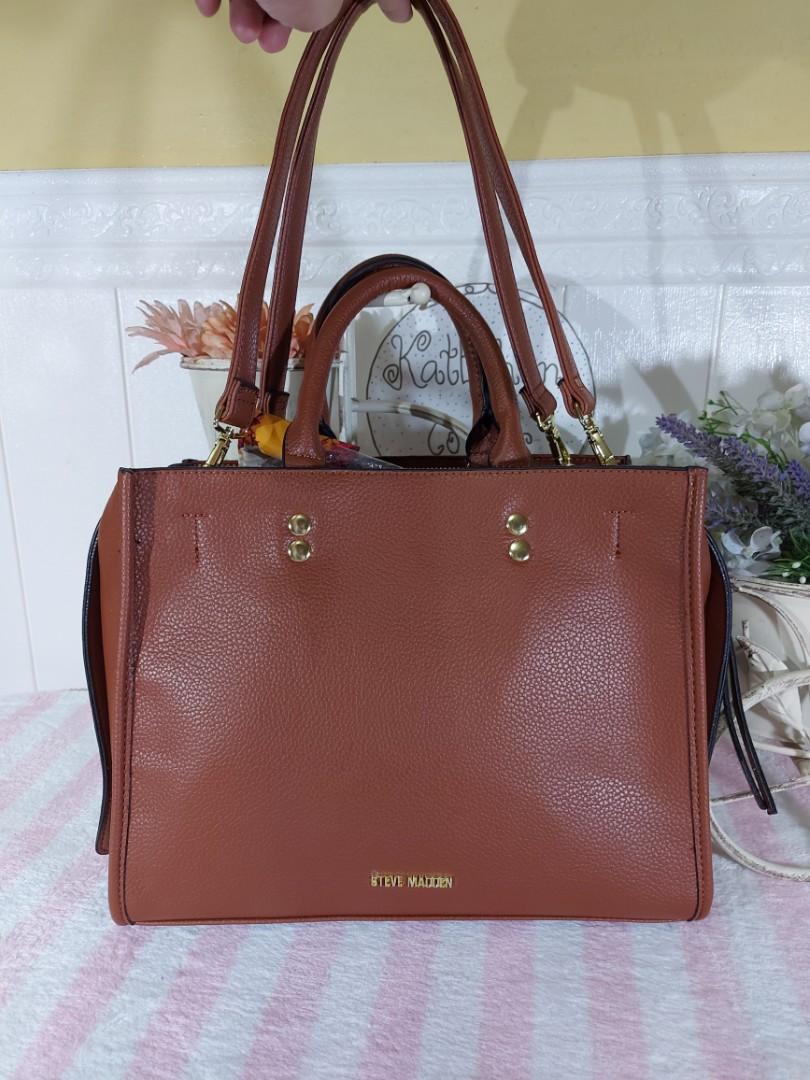 Steve Madden Two Way Shoulder Bag (Category: Shoulder Bags) located in Taguig. Submitted by katethanscorner (Listing ID 1095397580, Image 2). Description: STEVE MADDEN Bdannyy Cognac Satchel Bag With Zipper Closure & Inside Pockets Price: ₱3,500 - Brand New and Original -2 open inside pockets & 1 zipper closure inside pocket. -Bag Measurements: 10” H x 12” L x 5.5” W Mode of Payment: BDO, BPI Bank, GCash Shipping: LBC, Lalamove or Grab, buyer sho