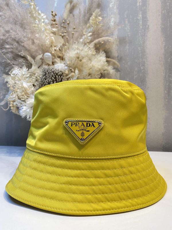 PRADA RENYLON BUCKET HAT yellow, Luxury, Accessories on Carousell