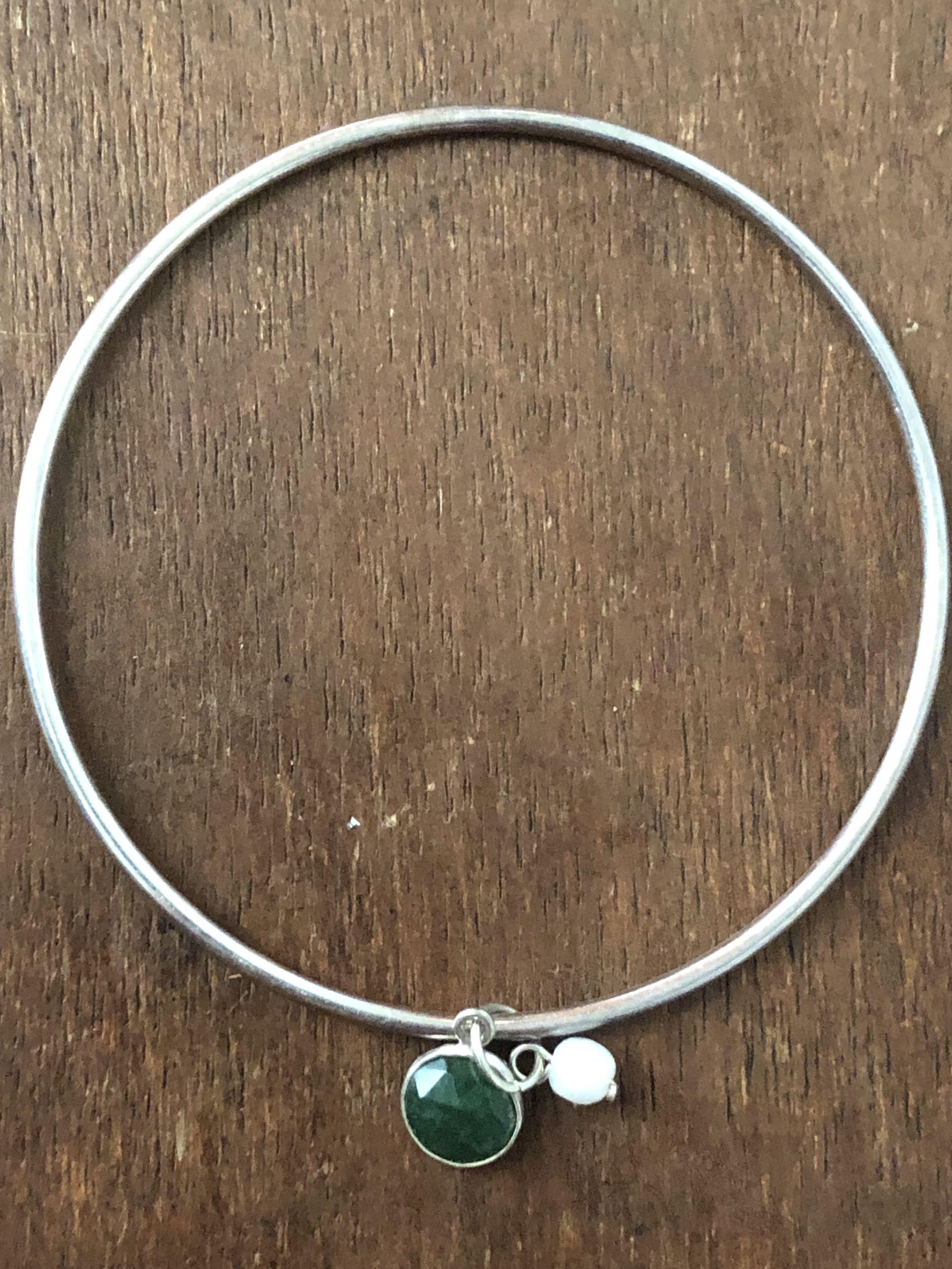 Silver bangle with Emerald and pearl (Category: Bracelets) located in Muntinlupa City. Submitted by declutter_with_me (Listing ID 1095888854, Image 1). Description: 92.5 Silver bangle with Emerald and fresh water pearl charms.