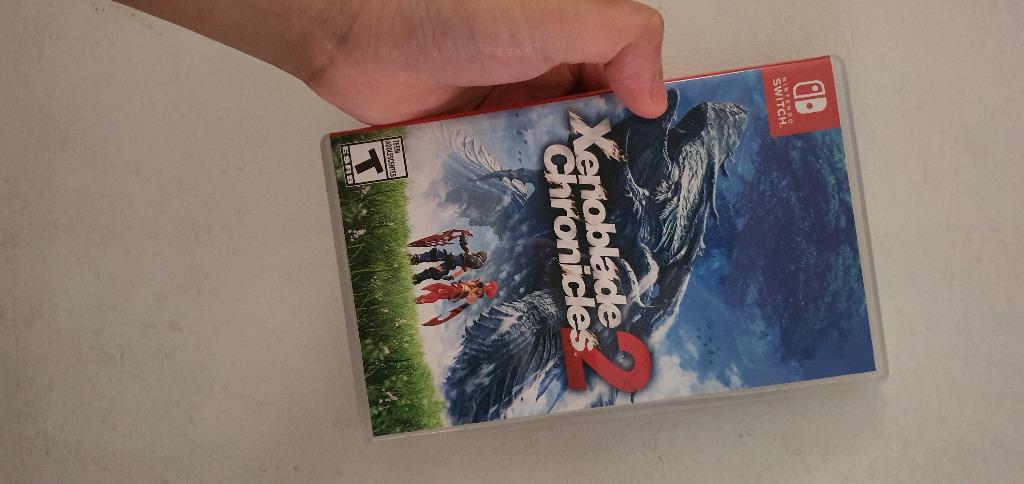 Selling: Xenoblade Chronicles 2 (Category: Nintendo) located in Manila. Submitted by ran493 (Listing ID 1096827617, Image 1). Description: Selling: Xenoblade Chronicles 2 (case is included) = 1,900.00 - item is super kept in good condition, ever since i bought this game last 2019 (meaning i am the only owner). - the gold coin points has already been redeemed years ago. RFS: tapos na laruin & hindi na nagalaw after matapos makuha lahat ng blades. 