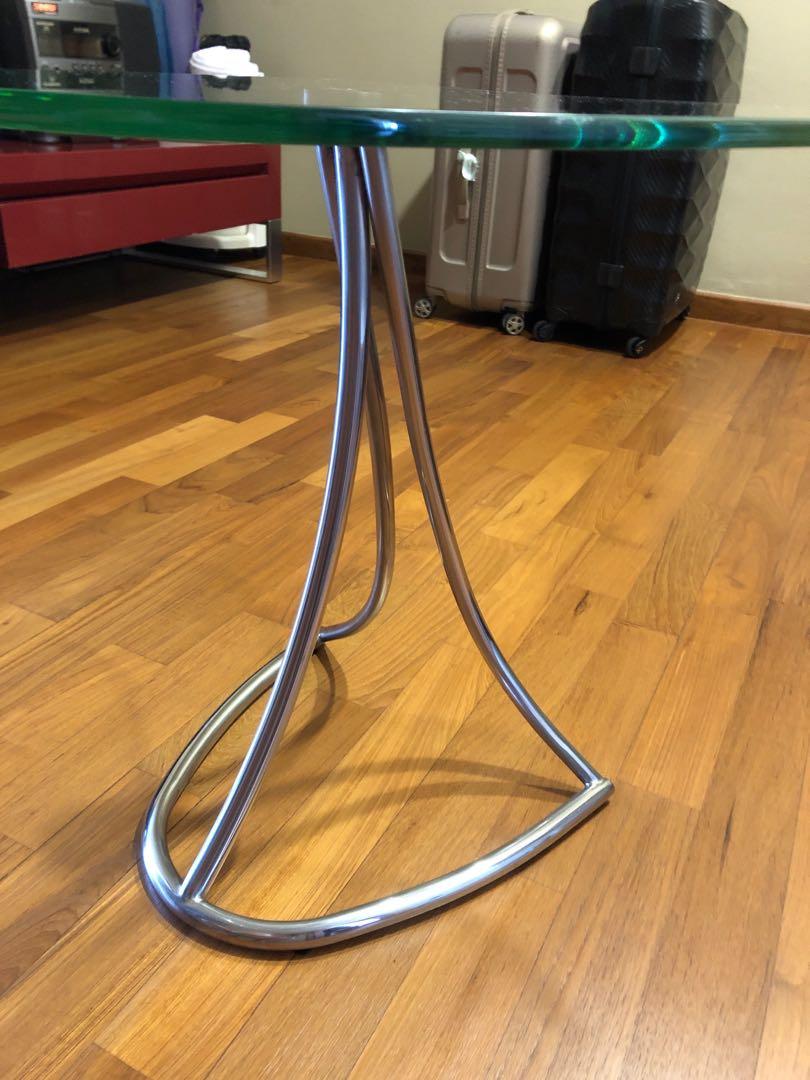 Side Table (Category: Tables & Sets) located in Singapore. Submitted by Murphy (Listing ID 1097608465, Image 2). Description: Can be used as side table or centre table between 2 sofa. Stainless steel leg with safety glass top. Good quality designer piece. Size about 21 inches (odd shape so base on maximum) .