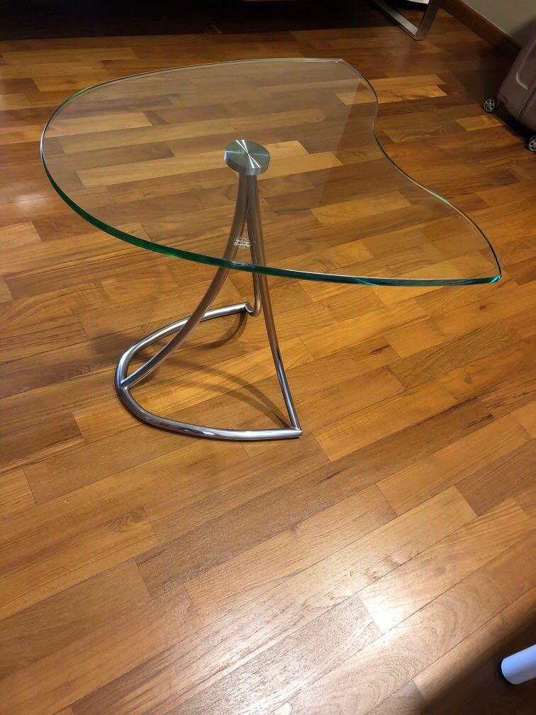 Side Table (Category: Tables & Sets) located in Singapore. Submitted by Murphy (Listing ID 1097608465, Image 1). Description: Can be used as side table or centre table between 2 sofa. Stainless steel leg with safety glass top. Good quality designer piece. Size about 21 inches (odd shape so base on maximum) .
