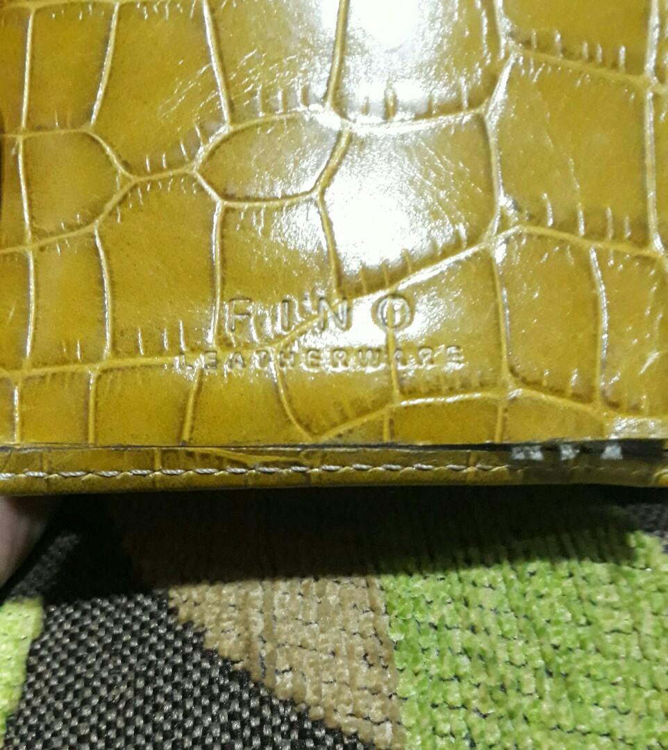 Fino Leatherware Tri-Fold Wallet (Category: Wallets & Card holders) located in Quezon City. Submitted by safeflower.62489b (Listing ID 1092547230, Image 2). Description: Color mustard Used few times only. In good condition except for a tear in one pocket. See last photo. Selling it because I don't need many pockets..