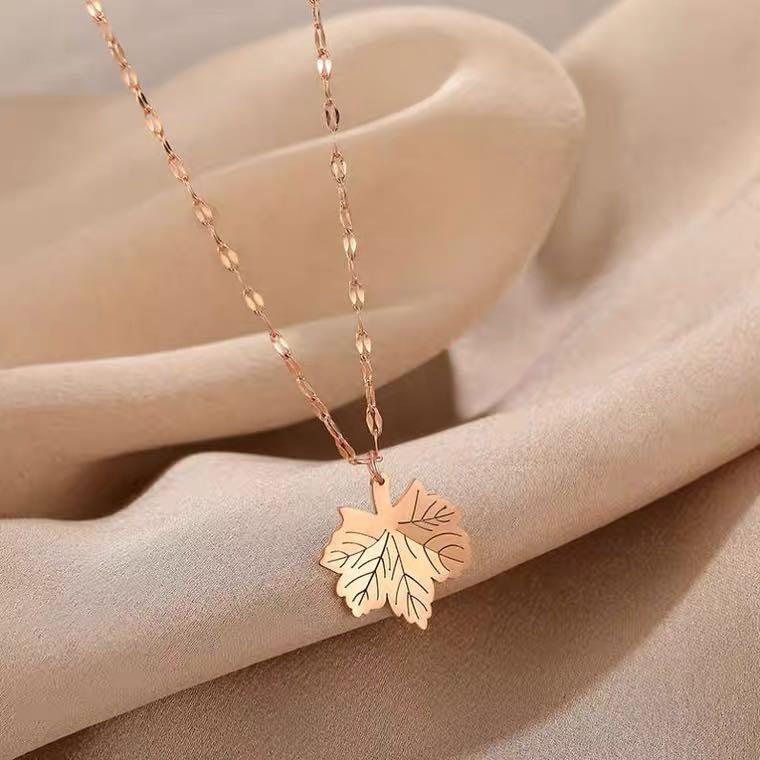 Gold maple leaf on sale necklace