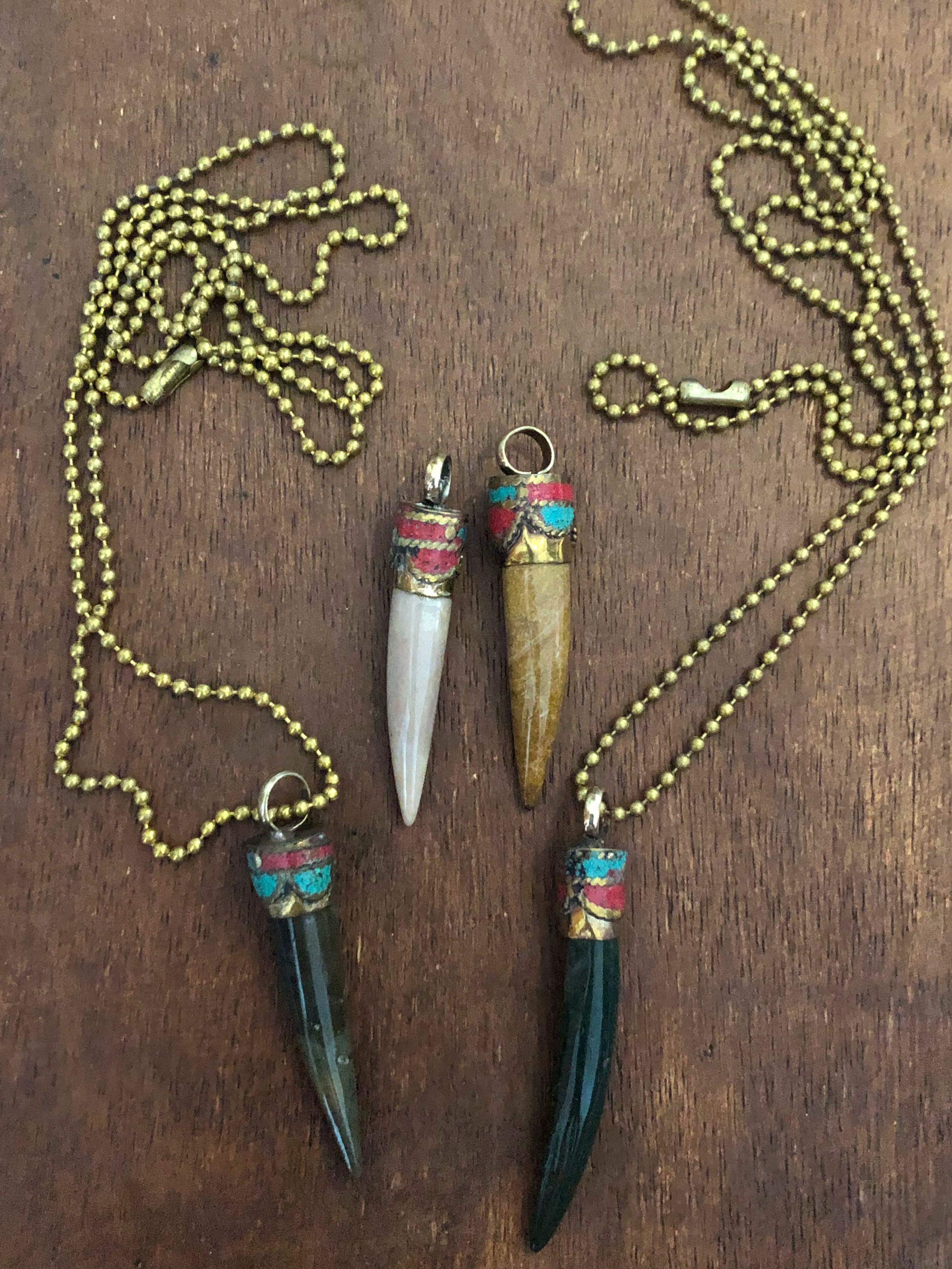 Stone pendant with Brass Ball Chain (Category: Necklaces) located in Muntinlupa City. Submitted by declutter_with_me (Listing ID 1093138562, Image 1). Description: ₱900 each With Brass Ball Chain L-R(Sunstone, Agate, Emerald, Agate).