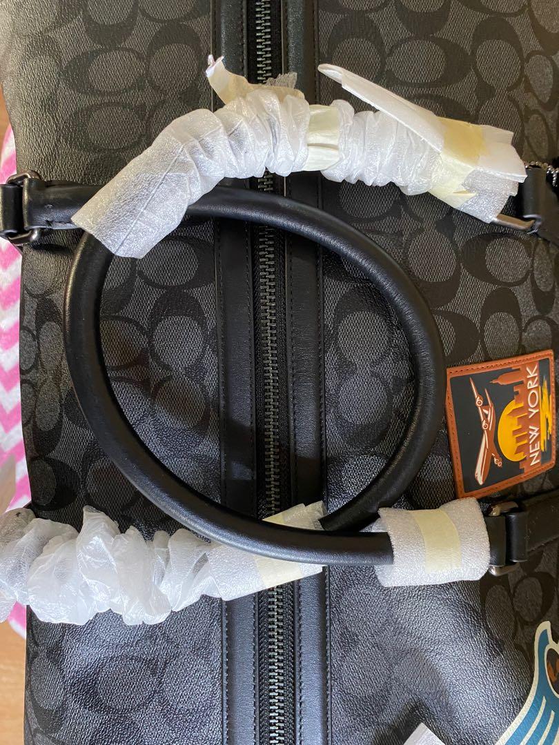 Trekker bag in signature canvas with travel patches top