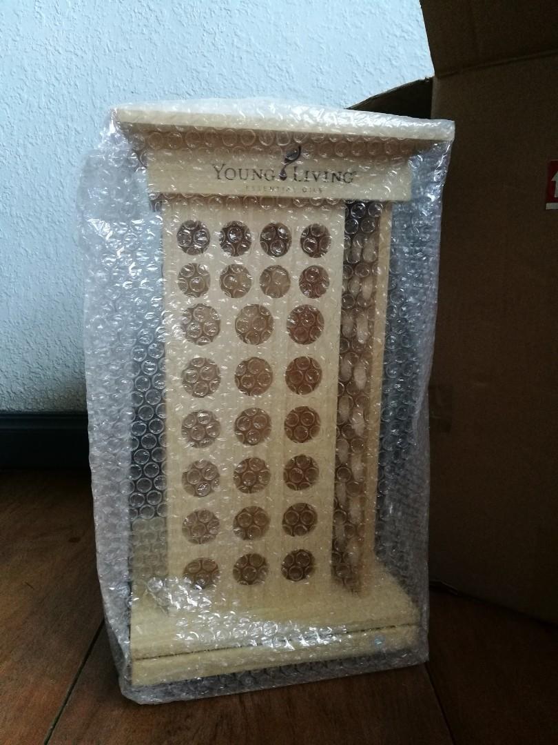 Young Living Essential Oil Rotating Rack (Category: Storage Boxes & Baskets) located in Quezon City. Submitted by fireflychic (Listing ID 1100909065, Image 2). Description: · authentic · brand new · with Box · Young Living · Essential Oil · Rotating Rack Display · Light Colored · Pine Wood · 9.5 " x 9.5" x 15 " · with swivel Base · 104 slots in total · 32 slots for 5ml bottles · 72 slots for 15 ml bottles · side tectangular slot for books / Catal