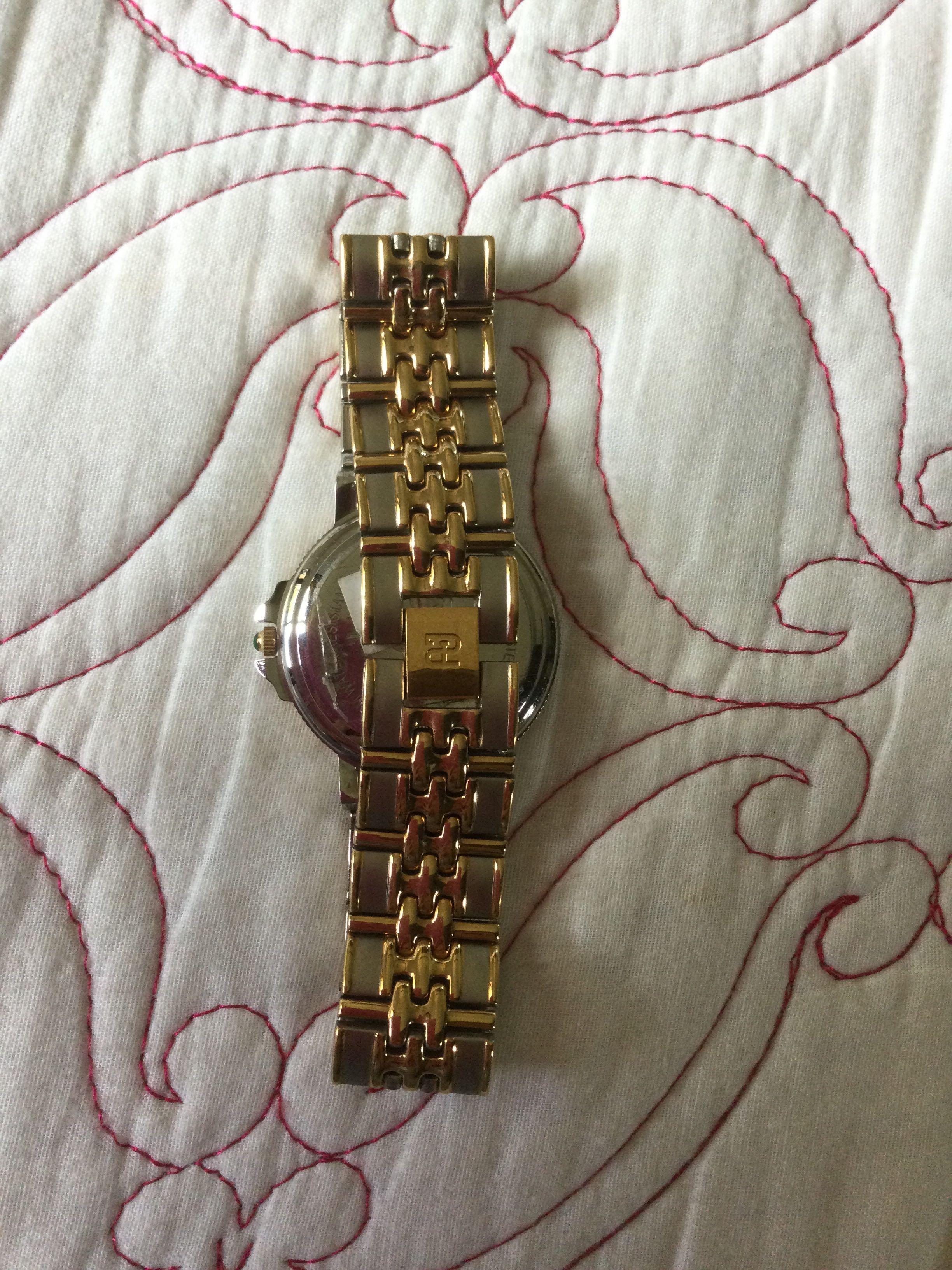 Paolo Gucci watch (Category: Men's Watches) located in Amadeo. Submitted by fbcollections (Listing ID 1101745710, Image 2). Description: 100% AUTHENTIC Paolo Gucci mens watch. 2-tone bracelet. Simple, classy Original box. Love this Watch! Crafted two-tone metal case and link bracelet, matte finish with highly polished accents. 30-meter water resistance Stainless steel case back Quartz movement .