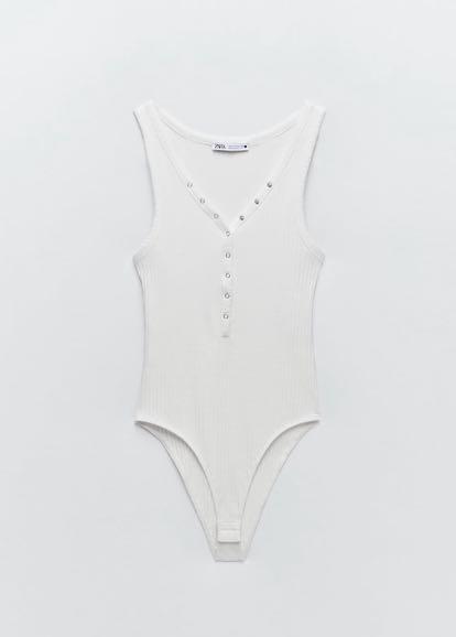 Zara Ribbed Bodysuit (Category: Others Tops) located in Quezon City. Submitted by mrvcs (Listing ID 1102137534, Image 2). Description: V neck bodysuit with wide straps. Snap-button detail on the front. Snap-button fastening at the bottom. Brand new RFS: not my size Slightly negotiable😅.