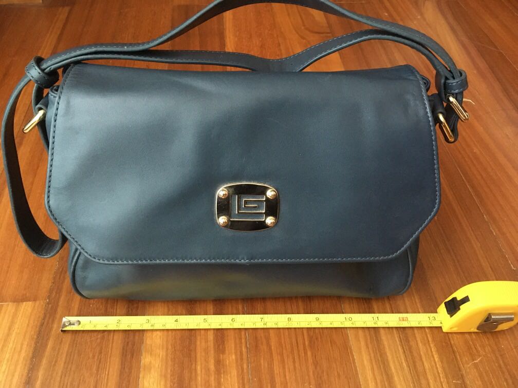 This Guy Laroche Paris navy Blue shoulder bag with gold charm