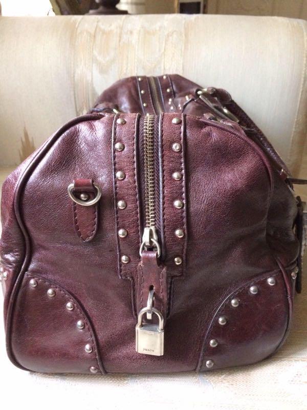 Prada talco Bauletto leather bag (Category: Luxury Bags & Wallets) located in Paranaque City. Submitted by jd555 (Listing ID 1103688718, Image 3). Description: prada talco bauletto Trunk style studded bag Made in Italy Pre-loved Color brown Size H 10” W 15” B 6” Inclusions- padlock & key Hangtag dust bag Coded Lampo zipper Black jacquard prada signature lining Flaws: Missing letter A in prada And shoulder strap Sold as is No other inclusion Payme