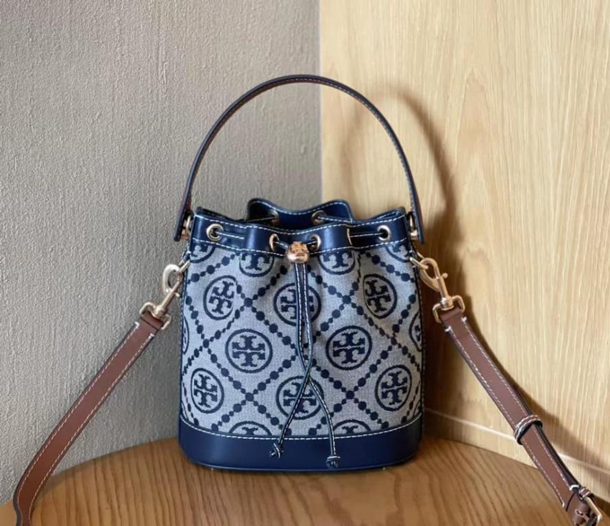 TORY BURCH T MONOGRAM JACQUARD BUCKET BAG NAVY (Category: Luxury Bags & Wallets) located in Santa Cruz. Submitted by janelovebagswatchesshoesph (Listing ID 1103629408, Image 1). Description: Woven jacquard, leather Brass-finish hardware; ecru stitching throughout The Goldfinch Yellow jacquard has a subtle shine Drawstring pull closure with push-lock; press and hold the Double T down while guiding the drawstrings through. Release to lock. Do not f
