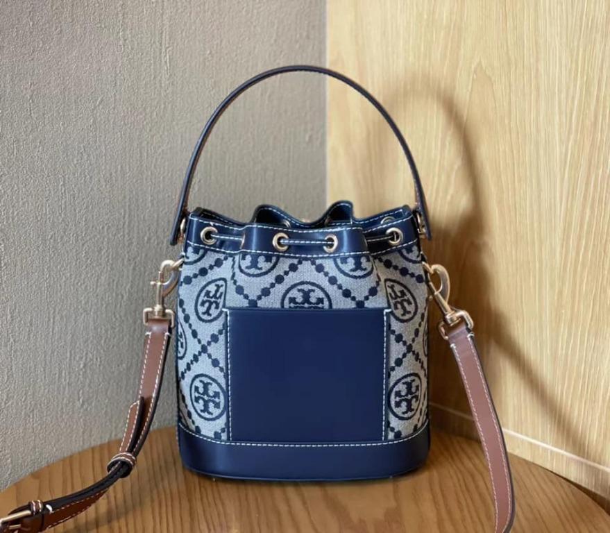 TORY BURCH T MONOGRAM JACQUARD BUCKET BAG NAVY (Category: Luxury Bags & Wallets) located in Santa Cruz. Submitted by janelovebagswatchesshoesph (Listing ID 1103629408, Image 2). Description: Woven jacquard, leather Brass-finish hardware; ecru stitching throughout The Goldfinch Yellow jacquard has a subtle shine Drawstring pull closure with push-lock; press and hold the Double T down while guiding the drawstrings through. Release to lock. Do not f