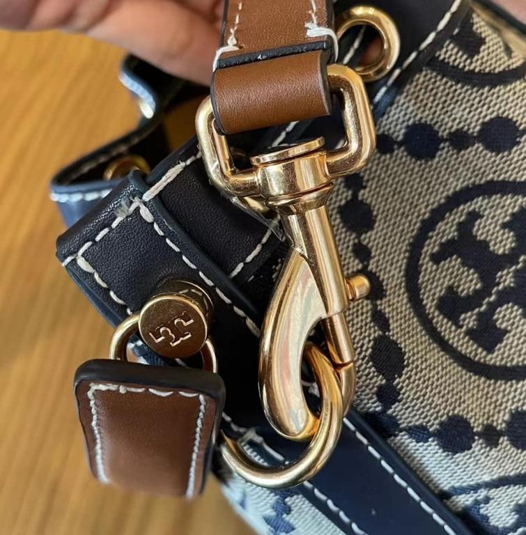 TORY BURCH T MONOGRAM JACQUARD BUCKET BAG NAVY (Category: Luxury Bags & Wallets) located in Santa Cruz. Submitted by janelovebagswatchesshoesph (Listing ID 1103629408, Image 3). Description: Woven jacquard, leather Brass-finish hardware; ecru stitching throughout The Goldfinch Yellow jacquard has a subtle shine Drawstring pull closure with push-lock; press and hold the Double T down while guiding the drawstrings through. Release to lock. Do not f