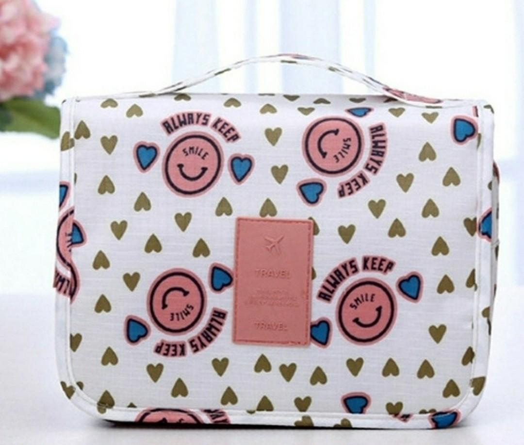 Multi function storage bag (Category: Travel Essentials & Accessories) located in Singapore. Submitted by ashcloub (Listing ID 1099658123, Image 1). Description: -nylon material -weight: 0.13kg -size: 22x 18x 8cm -white and pink smile design -can put cosmetics or shower products -courier (additional $3.90) or mailing.