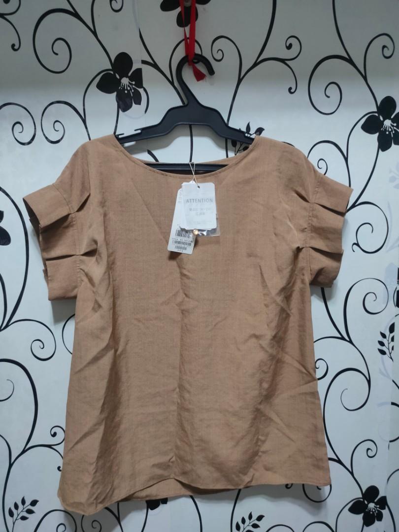 Plain brown blouse (Category: Blouses) located in Quezon City. Submitted by _apparels_ (Listing ID 1104350463, Image 1). Description: Brand new and never used. With tag and spare button Fits S to M body frame.