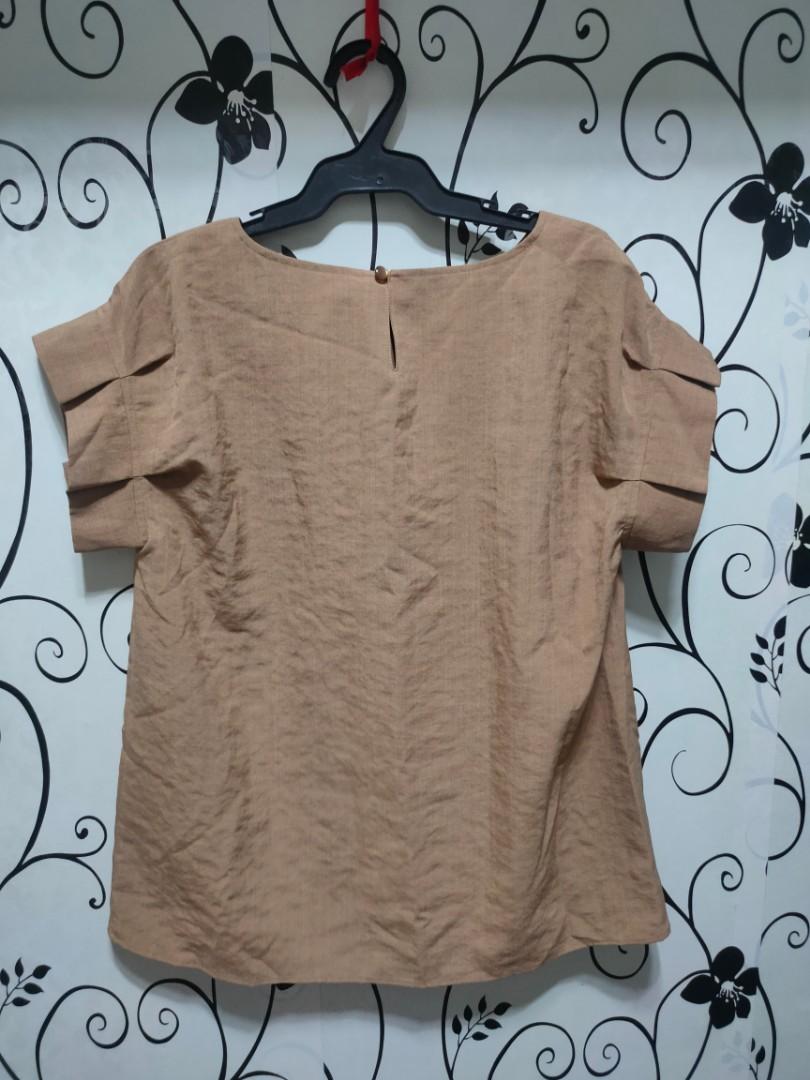 Plain brown blouse (Category: Blouses) located in Quezon City. Submitted by _apparels_ (Listing ID 1104350463, Image 2). Description: Brand new and never used. With tag and spare button Fits S to M body frame.