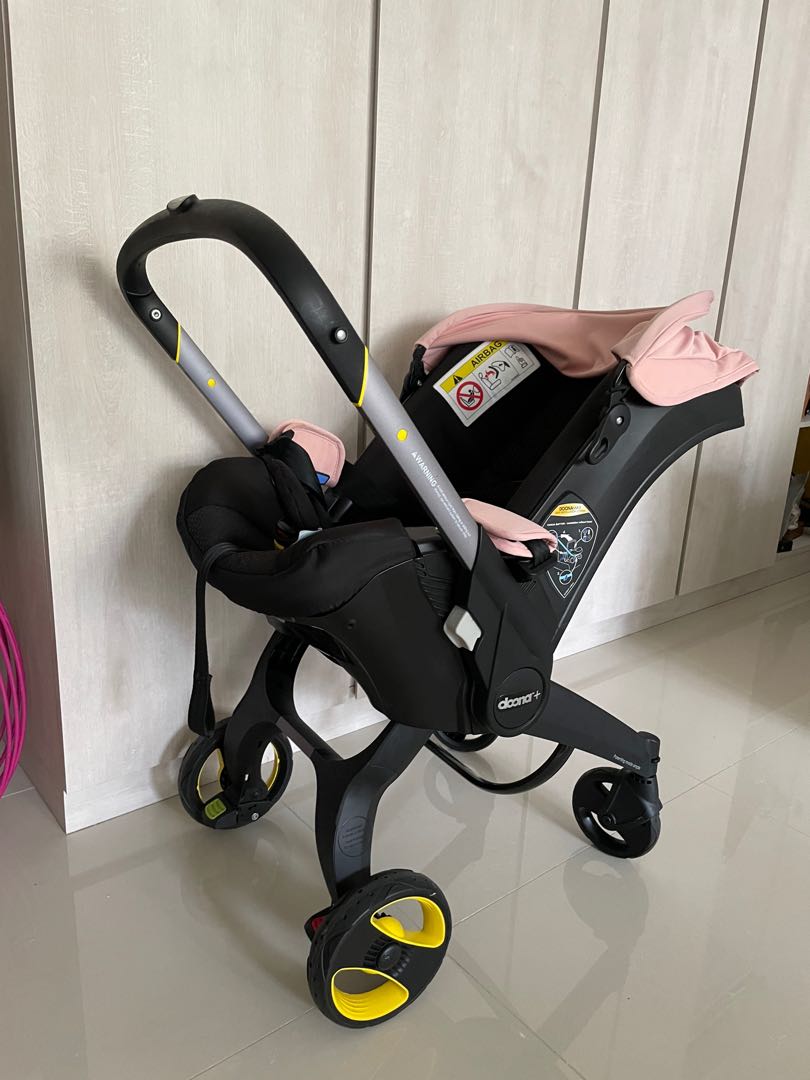 Doona pink stroller with iso fix and bag, Babies & Kids, Going Out