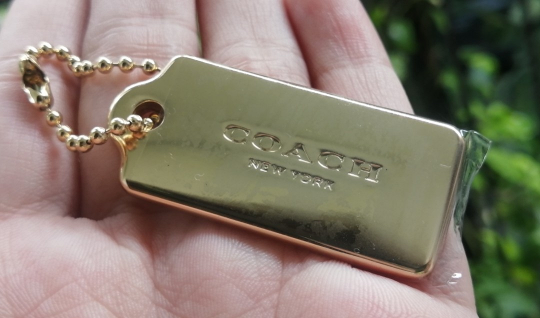 Coach gold on sale metal hang tag