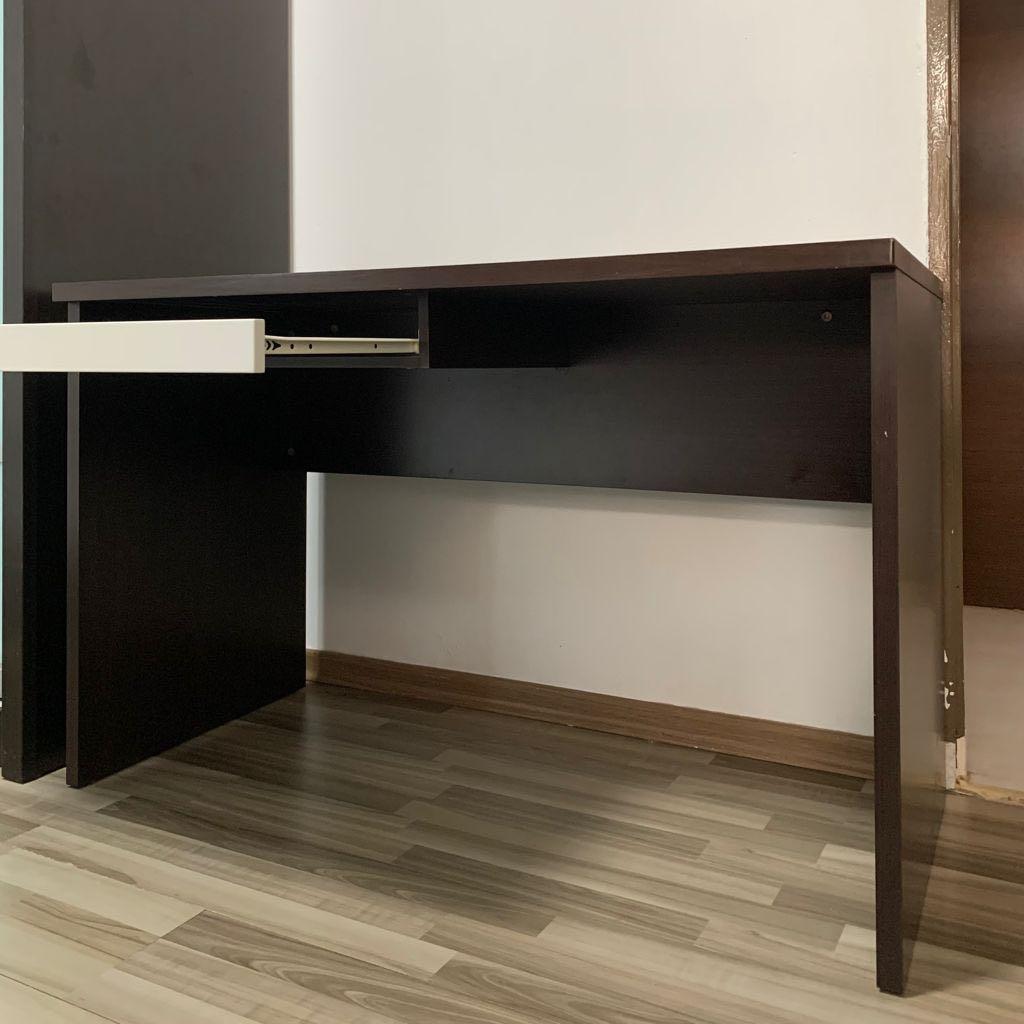 Solid wood study table (Category: Tables & Sets) located in Singapore. Submitted by moanalzy (Listing ID 1108744911, Image 1). Description: Table length: 120cm, width: 60cm, height: 76cm Drawer length: 60cm, width: 40cm -Drawer on the left side of table, cable management port at the top left corner -Dark brown durable solid wood -Please arrange delivery or self pick up at Tampines west area .