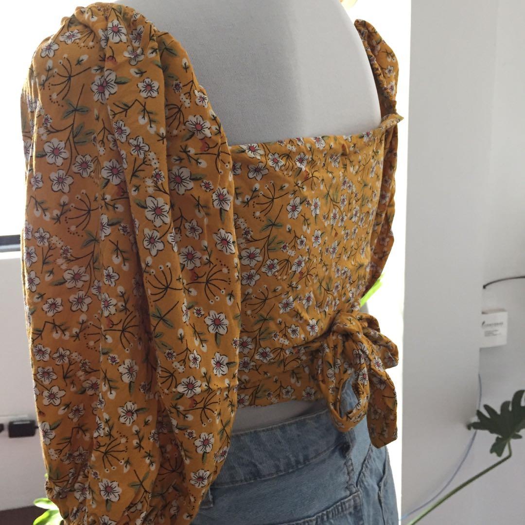 Yellow floral wrap croptop (Category: Blouses) located in Manila. Submitted by cb0903 (Listing ID 1108951205, Image 3). Description: Size small Used once No issue — good as new Rfs: decluttering Location: Marikina Delivery: mr speedy or gogo express Will give discount for two or more purchase! 💖.