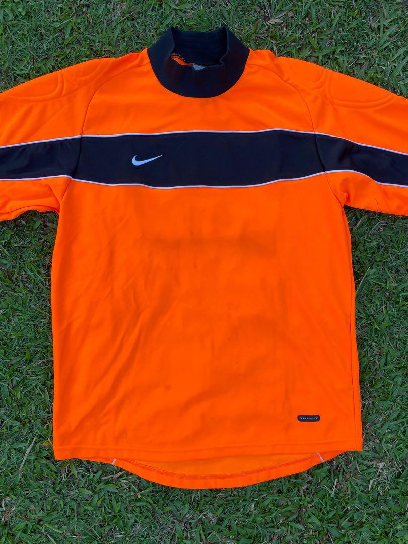 Vintage Nike goalkeeper soccer jersey in orange.