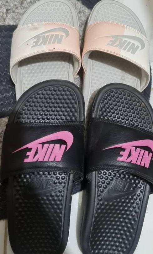 Pink and store black nike slides