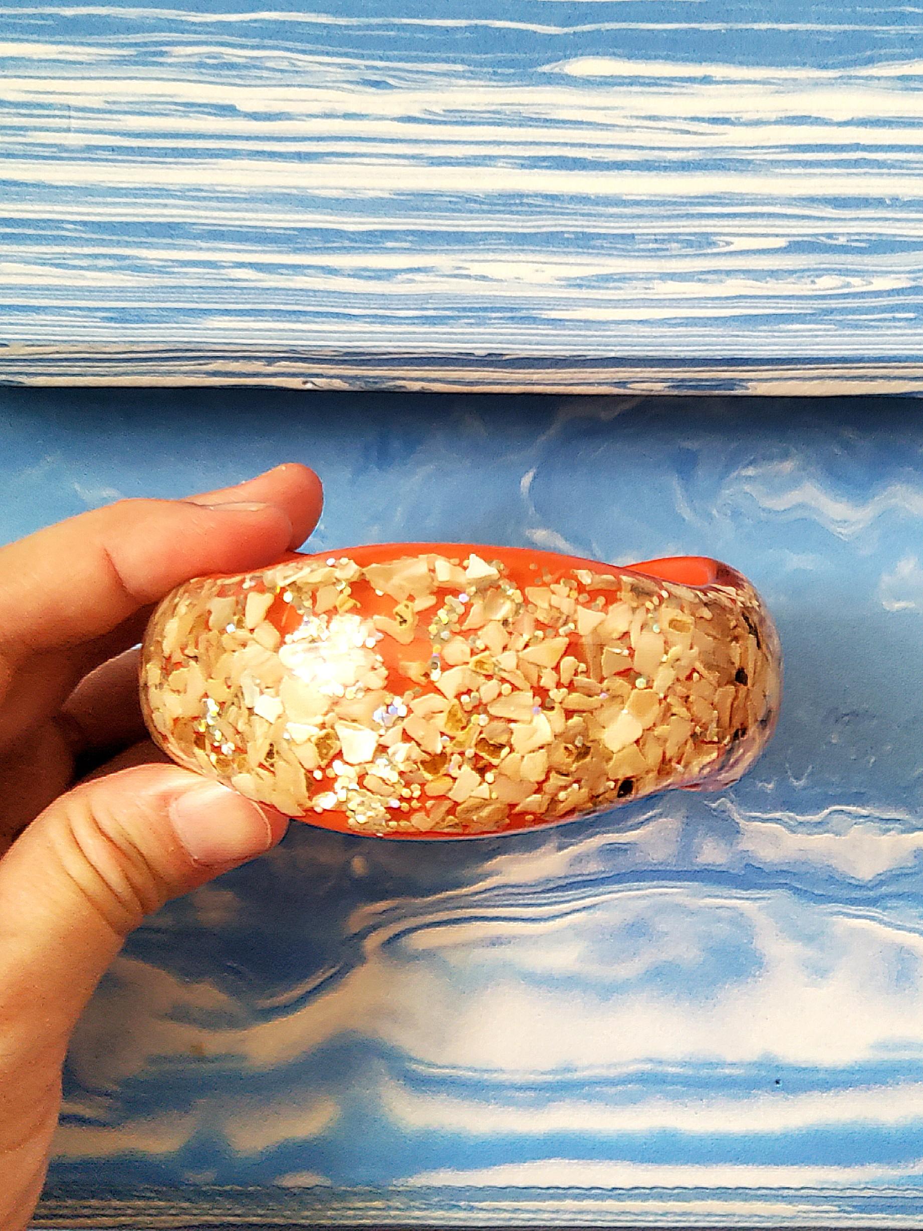 Vintage 70's Orange Resin Chunky Bangle (Category: Bracelets) located in Cainta. Submitted by thrifty_mama (Listing ID 1109195997, Image 2). Description: in excellent condition except with minor flaw in inner bangle. this is more or less a 5 decade old peice from my mom's personal accessories. it still looks exactly the same as i first saw it GCASH SHIPPING ONLY NO PICK UP.