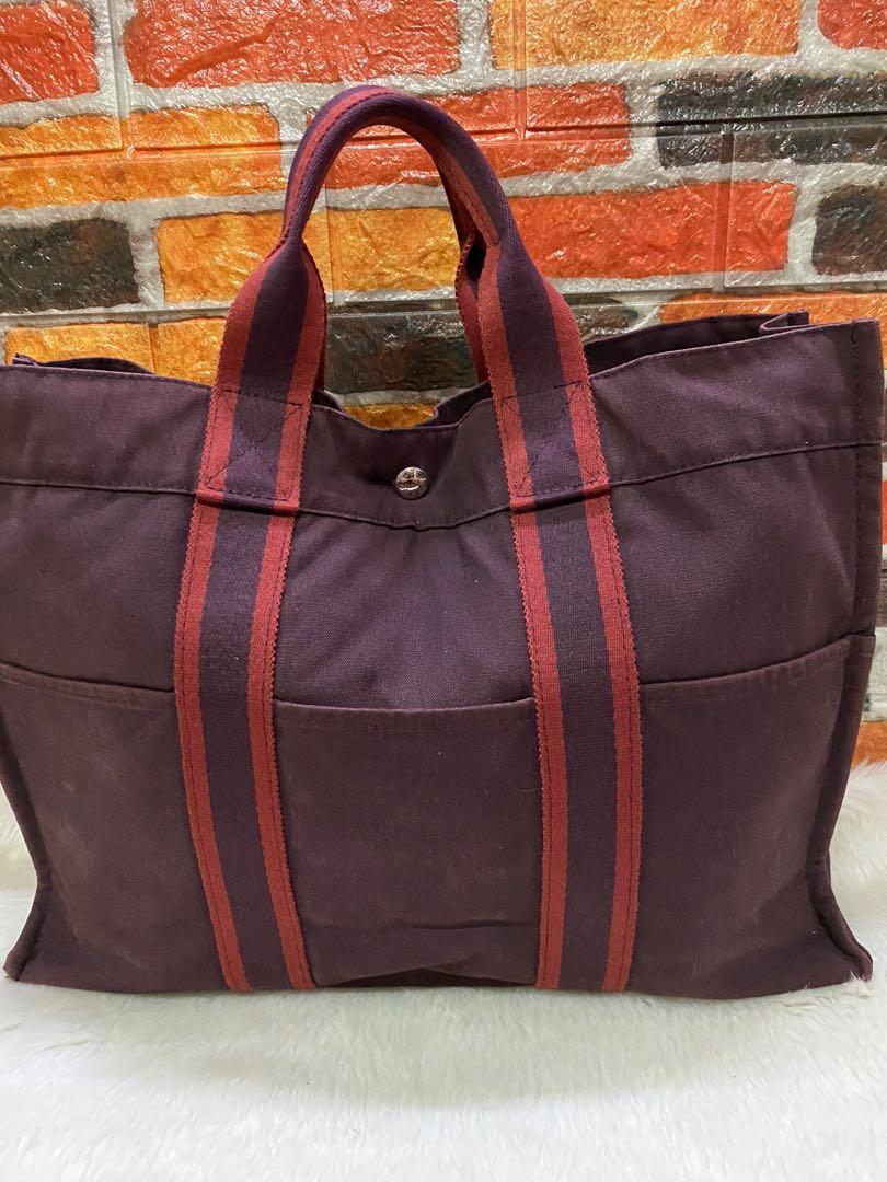 Authentic Hermès Canvas Tote Bag (Category: Luxury Bags & Wallets) located in Cagayan de Oro. Submitted by riggstuffs (Listing ID 1110393985, Image 2). Description: Preloved bag from Japan and guaranteed 💯 authentic Made in France Canvas material in Maroon and black color combination The exterior part is good except for some visible rubs at 2 corners of the bag Interior is good Riri zipper Rank AB in condition DISCLAIMER: Riggstuffs is not affil