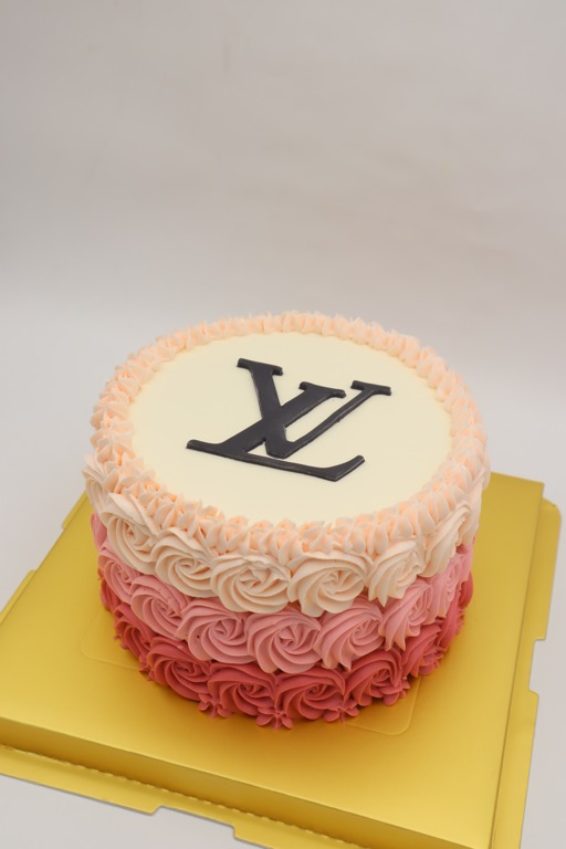Louis Vuitton themed cake iced in butter icing with 3D han…