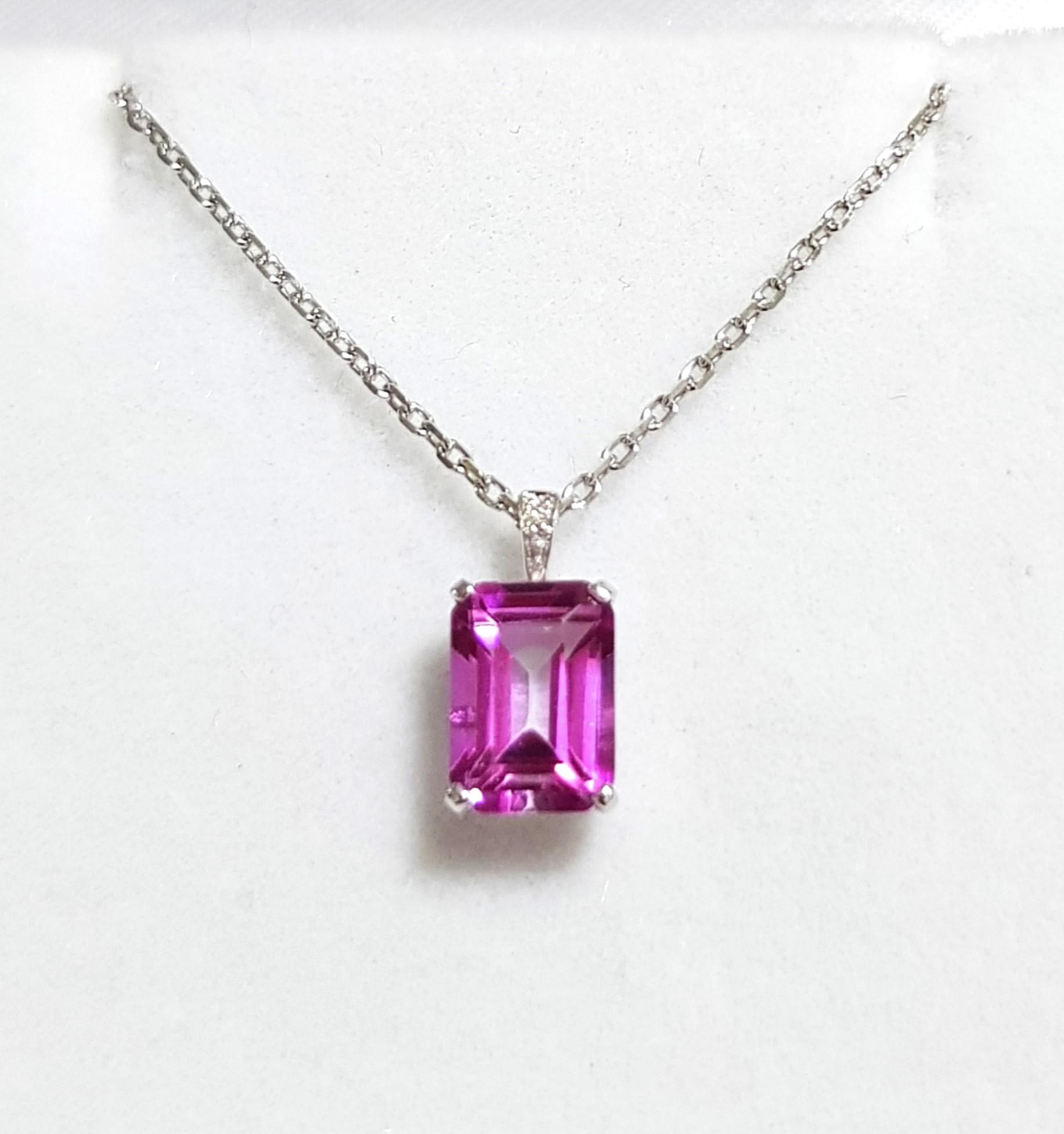 Sweet pink topaz pendant emerald cut with a diamond . Set in