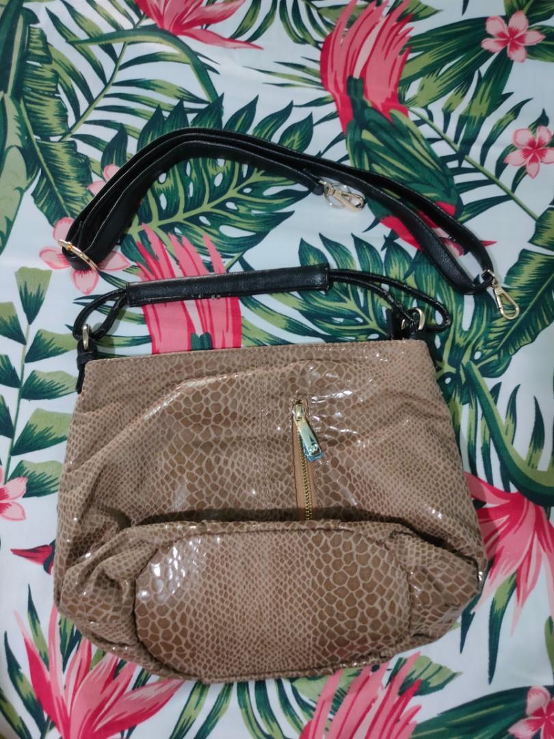 Michaella animal print shoulder bag (Category: Shoulder Bags) located in Quezon City. Submitted by _apparels_ (Listing ID 1105670697, Image 2). Description: Original Michaella shoulder bag Issue: leather handle (please see pic) Comes with additional strap that can be adjusted and bag can be a slingbag as well.